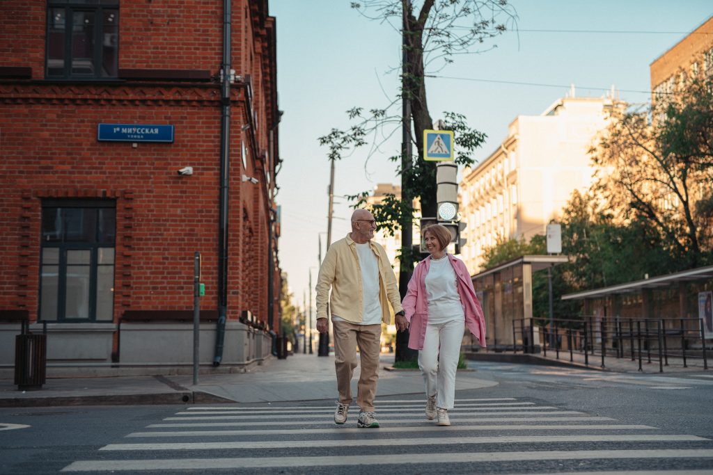 Old couple walking down the street holding hands